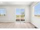 Bright living room featuring hardwood floors, and sliding glass door to backyard at 1957 S Coolidge Way, Aurora, CO 80018