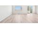 Bright living room featuring light wood floors and sliding glass doors to a patio at 1957 S Coolidge Way, Aurora, CO 80018