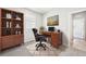 Cozy home office with a wood desk, comfortable chair, and built-in shelving at 1957 S Coolidge Way, Aurora, CO 80018