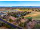 Stunning aerial view of homes on a golf course with mountain views in the background at 93 Glenmoor Dr, Cherry Hills Village, CO 80113