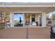 Back porch with stunning views features a seating area, wood decking, and stone columns at 93 Glenmoor Dr, Cherry Hills Village, CO 80113