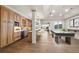 Spacious basement featuring a wet bar, hardwood floors, and a billiards area with large windows at 93 Glenmoor Dr, Cherry Hills Village, CO 80113