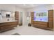 Bathroom featuring wood vanities with modern fixtures, neutral walls and tiled flooring at 93 Glenmoor Dr, Cherry Hills Village, CO 80113