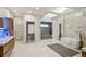 Spacious bathroom features soaking tub, walk-in glass shower, wood vanities, and tiled flooring at 93 Glenmoor Dr, Cherry Hills Village, CO 80113