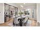 Elegant dining room with modern chandelier, large table, and views of the adjacent living spaces at 93 Glenmoor Dr, Cherry Hills Village, CO 80113