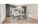 Dining room with hardwood floors, a stylish chandelier, bay windows and French doors for abundant natural light at 93 Glenmoor Dr, Cherry Hills Village, CO 80113