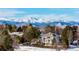 Scenic view of the home surrounded by trees and snow-capped mountains in the background at 93 Glenmoor Dr, Cherry Hills Village, CO 80113