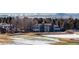 Beautiful home exterior overlooking a snow-covered golf course and mountain range at 93 Glenmoor Dr, Cherry Hills Village, CO 80113