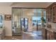 Open concept living and bar area with glass doors leading to views of mountains and greenery at 93 Glenmoor Dr, Cherry Hills Village, CO 80113