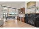 Bright open-concept living room featuring hardwood floors, stylish cabinetry, and modern fireplace with artistic mantle decor at 93 Glenmoor Dr, Cherry Hills Village, CO 80113