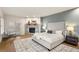 Cozy bedroom featuring stone fireplace, tufted headboard, hardwood flooring, and French doors for abundant natural light at 93 Glenmoor Dr, Cherry Hills Village, CO 80113