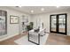 Well-lit home office featuring a modern desk, storage shelves, and stylish French doors at 93 Glenmoor Dr, Cherry Hills Village, CO 80113