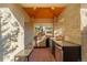 Covered outdoor kitchen equipped with a built-in grill, sink, and counter space at 93 Glenmoor Dr, Cherry Hills Village, CO 80113