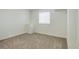 Simple, carpeted bedroom with a window and closet at 18455 W 94Th Ave, Arvada, CO 80007