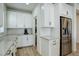 White kitchen with stainless steel appliances and pantry at 18455 W 94Th Ave, Arvada, CO 80007