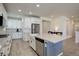 Modern kitchen with white cabinets, stainless steel appliances, and an island at 18455 W 94Th Ave, Arvada, CO 80007