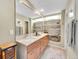 Modern bathroom with granite countertop, ample storage shelves, and a large mirror at 3706 E Easter Dr, Centennial, CO 80122