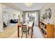 Spacious dining room with stylish chairs, wooden table, and seamless flow to the living area at 3706 E Easter Dr, Centennial, CO 80122