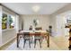 Bright dining room featuring a dark wood table, neutral colors and an adjacent kitchen area at 3706 E Easter Dr, Centennial, CO 80122