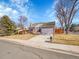 Traditional home featuring a well-manicured lawn and a spacious driveway at 3706 E Easter Dr, Centennial, CO 80122