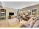 Sunlit living room featuring plush sofas, stylish decor, and a view to the backyard at 3706 E Easter Dr, Centennial, CO 80122