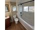 Updated bathroom features a white tiled shower-tub combo, and a modern vanity at 1129 2Nd Ave, Longmont, CO 80501