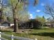 Charming home with large mature trees, fenced yard, and lush green grass at 1129 2Nd Ave, Longmont, CO 80501