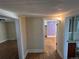 A cozy hallway with hardwood floors offering views into multiple rooms at 1129 2Nd Ave, Longmont, CO 80501