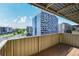 Balcony view of a neighborhood with a tall building with blue accents on a sunny day at 4110 Hale Pkwy # 5F, Denver, CO 80220