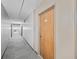 Long hallway with gray carpet leading to unit door with number 58, lit by ceiling lights at 4110 Hale Pkwy # 5F, Denver, CO 80220