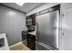 Kitchen with stainless steel appliances, dark wood cabinetry and modern backsplash at 4110 Hale Pkwy # 5F, Denver, CO 80220