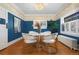 Elegant dining room featuring hardwood floors, contemporary light fixture and vibrant wall color at 1827 N Bellaire St, Denver, CO 80220