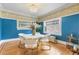 Charming dining room with hardwood floors, blue walls, and stained glass windows at 1827 N Bellaire St, Denver, CO 80220