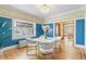 Formal dining room with hardwood floors, blue walls, and stained glass windows at 1827 N Bellaire St, Denver, CO 80220