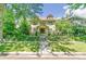 Two-story house with a classic design, landscaped yard, and a metal fence at 1827 N Bellaire St, Denver, CO 80220