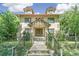 Brick two-story house with a classic design, landscaped yard, and a metal fence at 1827 N Bellaire St, Denver, CO 80220