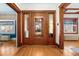 Inviting foyer featuring decorative hardwood floors, stained glass windows, and a grand wooden front door at 1827 N Bellaire St, Denver, CO 80220