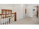 Upstairs hallway with a stained glass window and access to a bathroom with vintage elements at 1827 N Bellaire St, Denver, CO 80220