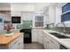 Updated kitchen with quartz countertops, stylish backsplash, and modern appliances at 1827 N Bellaire St, Denver, CO 80220