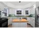 Bright kitchen with modern appliances, butcher block island, and ample cabinet space at 1827 N Bellaire St, Denver, CO 80220