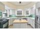 Modern kitchen with white cabinets, butcher block island, and stainless steel appliances at 1827 N Bellaire St, Denver, CO 80220