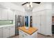 Bright kitchen with stainless steel refrigerator, butcher block island, and custom cabinets at 1827 N Bellaire St, Denver, CO 80220