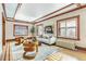 Living room with hardwood floors, fireplace, and large windows with shutters at 1827 N Bellaire St, Denver, CO 80220