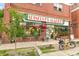 Spinelli's Market storefront with brick facade, flowers, and outdoor seating at 1827 N Bellaire St, Denver, CO 80220