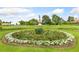 Landscaped garden with a central statue and vibrant flowers at 1827 N Bellaire St, Denver, CO 80220