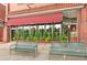 The Cherry Tomato restaurant exterior, featuring a red awning and green plants at 1827 N Bellaire St, Denver, CO 80220