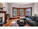 Sunlit living room features hardwood floors, a fireplace, and a bay window providing ample natural light at 836 E 17Th Ave # 2E, Denver, CO 80218