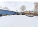 Large snow-covered backyard with covered patio, gazebo, and mature trees at 7966 Ingalls St, Arvada, CO 80003