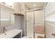 Contemporary bathroom with a glass shower, floating shelves, and modern fixtures at 7966 Ingalls St, Arvada, CO 80003