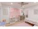 Charming bedroom with pink accents, light wood floors, and whimsical decor at 7966 Ingalls St, Arvada, CO 80003